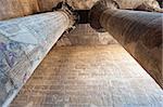 Columns in the ancient egyptian temple of Khnum at Esna with hieroglyphic carvings