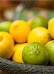 Basket full with green and yellow citrus fruits