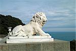 sculpture of a lion against the sea