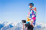 Young man with skis and a ski outfit in the Zillertal Arena, Austria