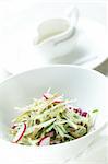 Fresh and tasty salad in white dish