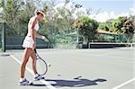portrait of young beautiful woman playing tennis in summer environment