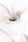 close up view of two wedding rings on white back