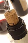 Opening a wine bottle and two wine glasses at background.(Shallow DOF)