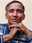 Portrait of happy mature Asian man smiling and looking at camera