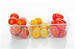 Multicolored cherry tomatoes in a bowl isolated on white background