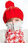 Portrait of young smiling cute frozen teenager in a red hat and mittens, isolated on white