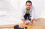 Installing laminate flooring - man working on the floor