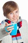 Portrait of young smiling cute frozen teenager in a scarf and with blue cup, isolated on white. Focus on the white