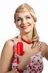 Young pretty girl with color make up hairstyle and color dress drinking from colored bottle some drink, she takes the red bottle with right hand, smile and looks up with dreamy eyes