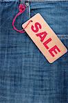 Closeup of Blue Jeans With Brown Sale Tag