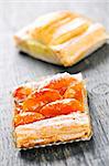 Closeup on two slices of flaky fruit strudel desserts