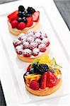 Closeup of fancy gourmet fresh fruit dessert tarts