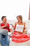 Happy pregnant woman with husband shopping on Internet