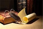 Vintage library still life. Old books, spectacles,scroll, quill pen