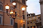 Closeup of vintage glowing street lamp in Rome, Italy