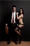 Business man embraced with a sexy young woman in lingerie. Concept about work and pleasure
