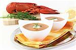 fresh lobster soup with lemon, dill and cream dollop