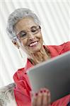 Stylish senior Black woman using a digital tablet