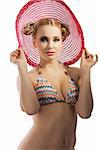 fashion shot of blond sensual lady in bikini taking pose with hat and hair style