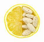 Close up of lemon and pills isolated - vitamin concept - vitamin c