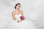 Brunet bride portrait with flowers in studio