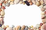 Frame made of sea pebbles and shells on white background