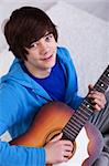 Happy teenager with guitar - closeup