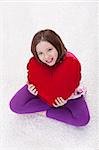 Happy young girl with large red heart pillow - valentie's day is coming