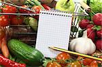 Shopping list with basket and fresh vegetables on a wooden background