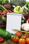 Basket with fresh vegetables and shopping list and pencil on a wooden background