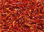 close up of dried red chili flakes food background