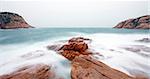 rocky sea coast and blurred water in shek o,hong kong