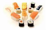 Japanese sushi with salmon, shrimp, carrots and cucumber on a light background