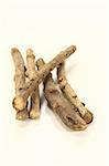 dried licorice root with licorice flavoured on a bright background