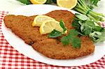 freshly roasted wiener schnitzel with lemon slices and parsley