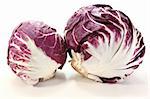 two heads of fresh radicchio on a light background