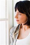 Smiling woman standing by window