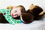 Boy hugging teddy bear in bed