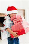 Boy in Santa hat with Christmas gifts