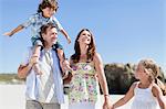 Famille marcher ensemble sur la plage