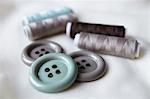 Close up of buttons and spools of thread