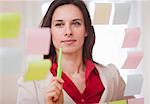 Businesswoman reading sticky notes