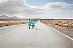 Children walking on paved rural road