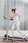 Woman using exercise machine