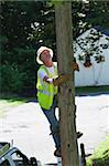 Lineman climbing a pole for installation