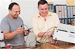 Engineering students using oscilloscope and function generator