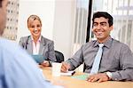 Business executives smiling in a meeting