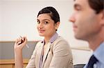 Portrait of a female executive in a meeting