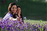 Mother and daughter plucking flowers